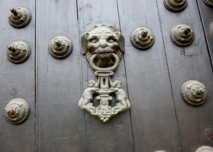 a door knocker with naked little critters