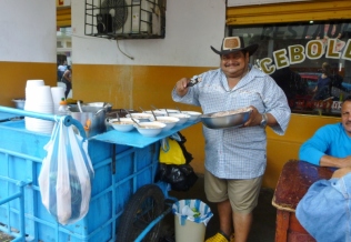 serving up the meals - enceballado soup - Manta, Ecuador